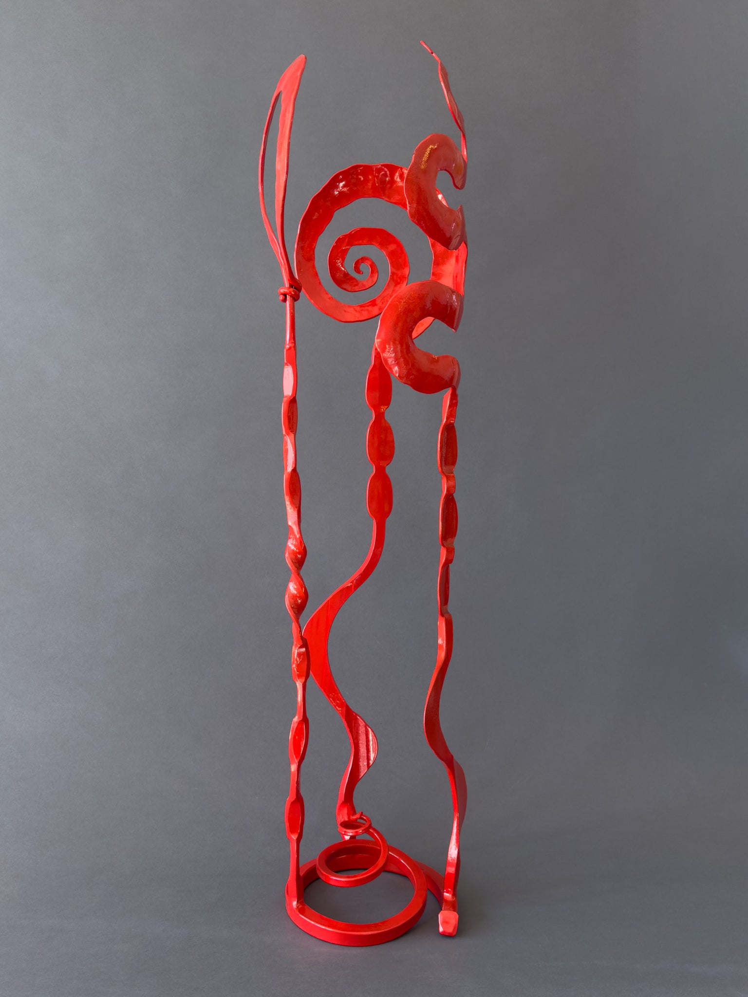 Small red abstract hand forged steel sculpture by blacksmith artist, Christopher Thomson.