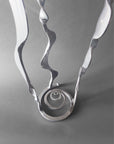 Spiral sculpture base with a powder coated chrome finish.