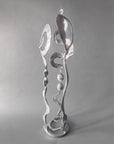 Side view of Chrome Baby Bloom steel sculpture showing Meander form winding through the stem and spiral base