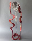 Abstract steel Baby Bloom sculpture showcasing intersecting chrome and metallic copper elements that create changing perspectives from every viewing angle.