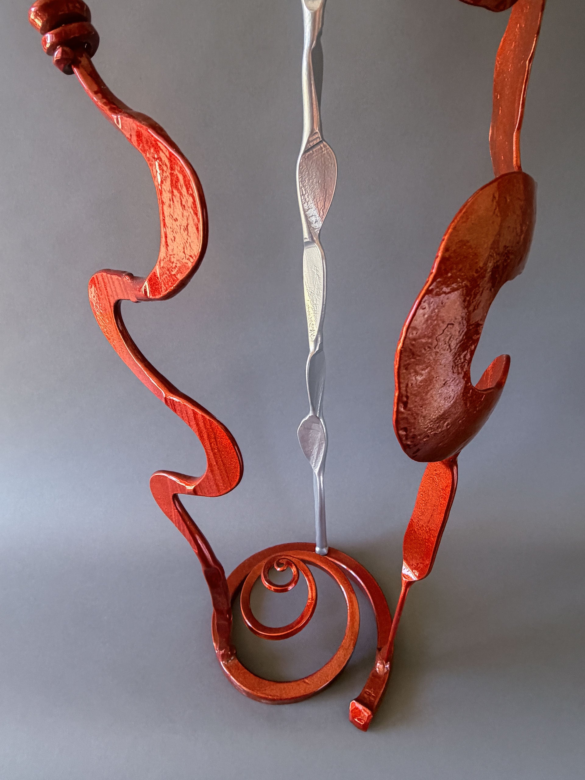 Detail of the hand forged steel base and lower sculptural elements of the Copper &amp; Chrome Baby Bloom, highlighting craftsmanship and powder-coated finishes.