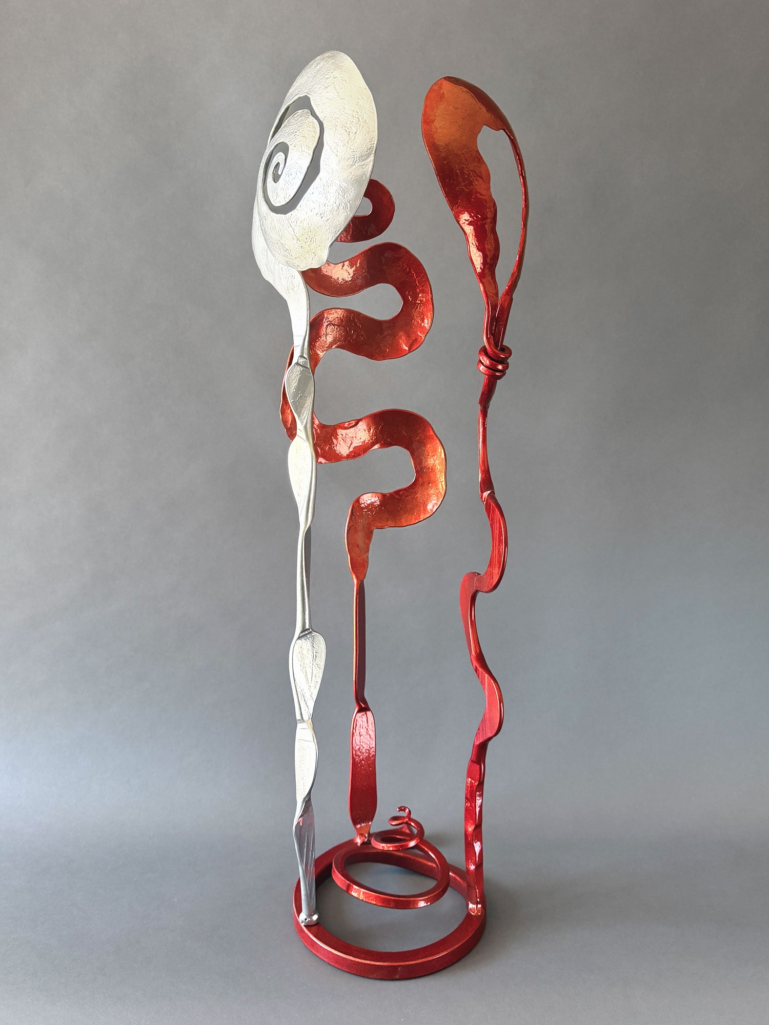 Hand forged Baby Bloom sculpture by Christopher Thomson with sweeping copper colored forms, polished chrome accent, and a dynamic free-standing composition.