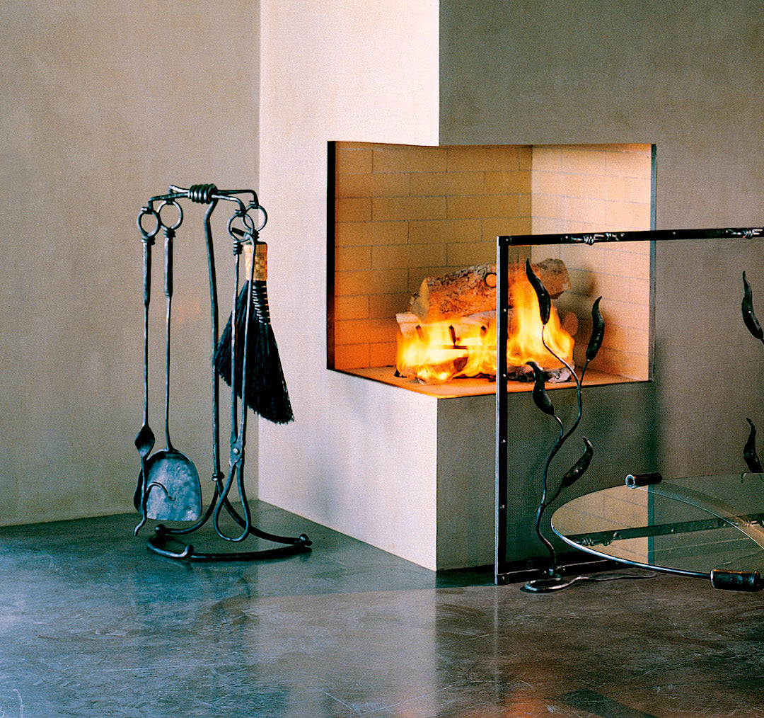 Wrought Iron fireplace tools on display in a luxury home.