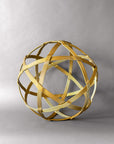 Front view of a 19-inch gold steel orb sculpture showing six woven bands framing triangles and pentagons
