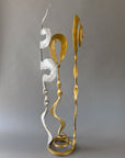 Gold and chrome Baby Bloom steel sculpture by Christopher Thomson with spiral top and flowing forged elements on a freestanding circular base.