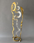 Contemporary steel Baby Bloom sculpture with reflective chrome center and gold forged elements displayed against a neutral background.