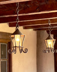 Two large hanging wrought iron lanterns.