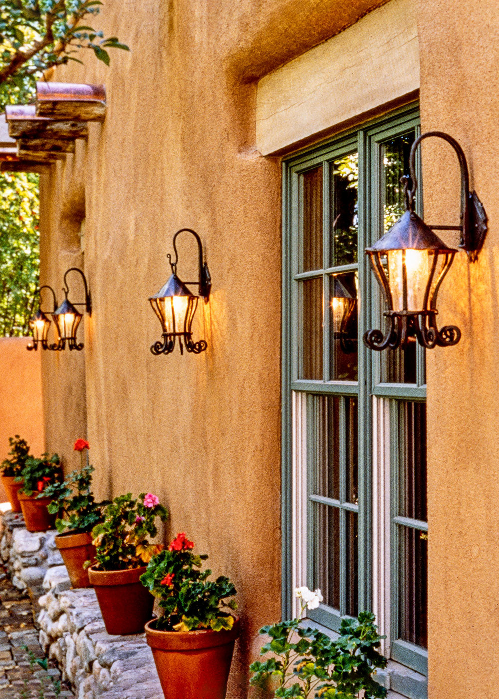 Hanging Wall Lanterns outside on an adobe wall.