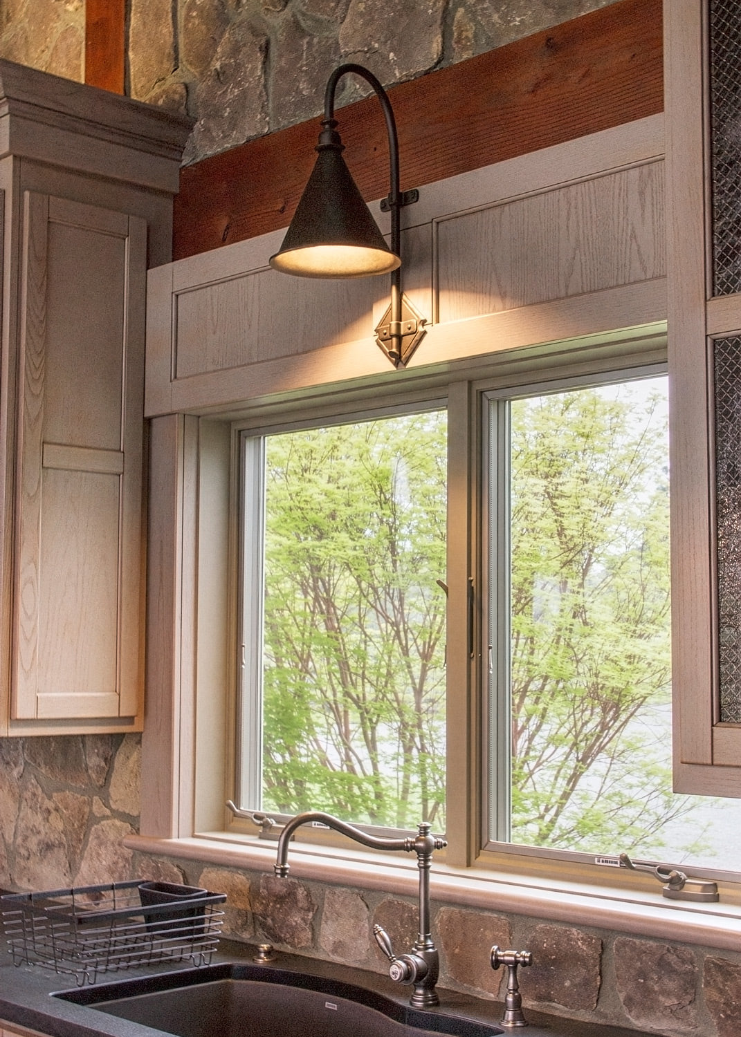 Large Entry Iron Sconce above a kitchen sink.