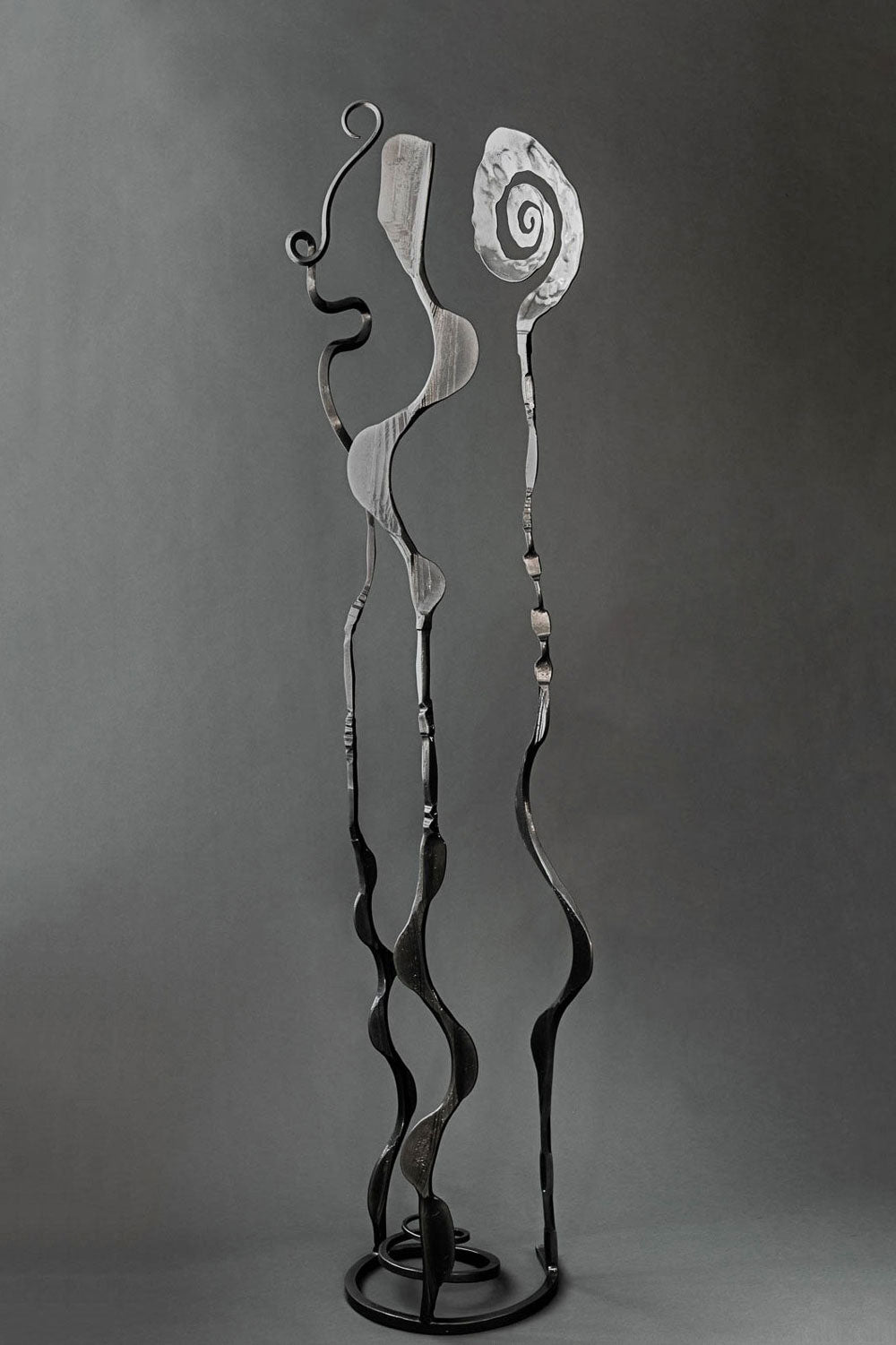 Metallic black hand forged abstract garden sculpture that can also be place indoors. 