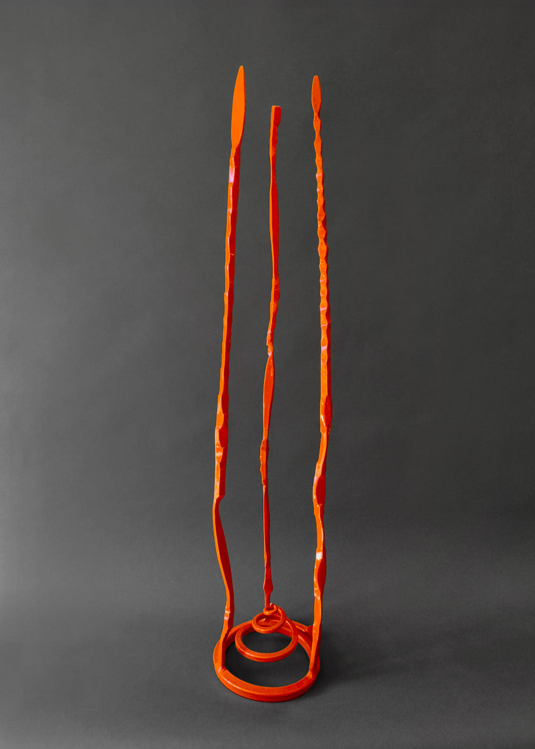 Orange minimalist hand forged steel sculpture.