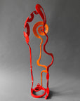 Back view of orange and red Baby Bloom steel sculpture showing red Loop and Meander forms, one of a kind, hand forged in New Mexico