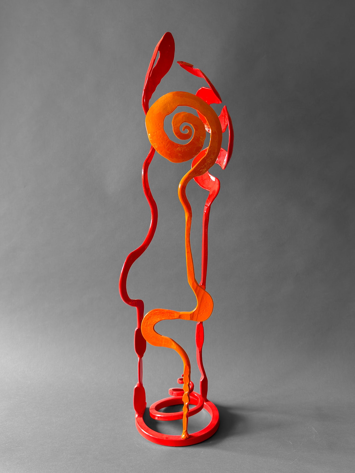 Side view of orange and red Baby Bloom showing orange Rose spiral form, hand forged steel sculpture, Northern New Mexico
