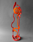 Side view of orange and red Baby Bloom showing orange Rose spiral form, hand forged steel sculpture, Northern New Mexico