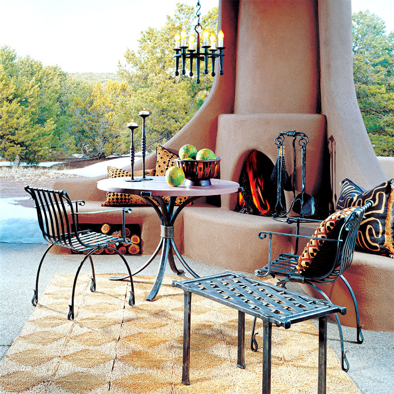 Outdoor patio scene showcasing Christopher Thomson's designer iron furniture.