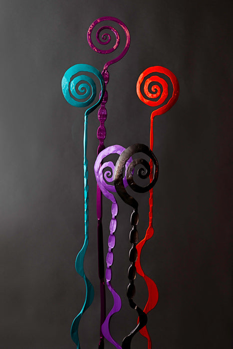 Rose metal sculptures made out of steel in a variety of colors.