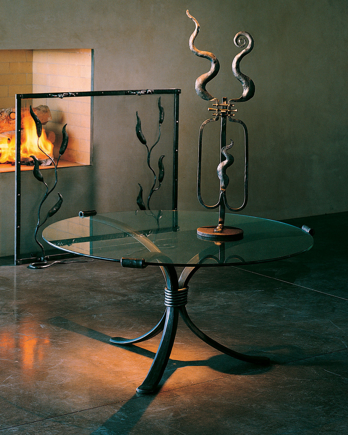 Round wrought iron coffee table with a glass top.
