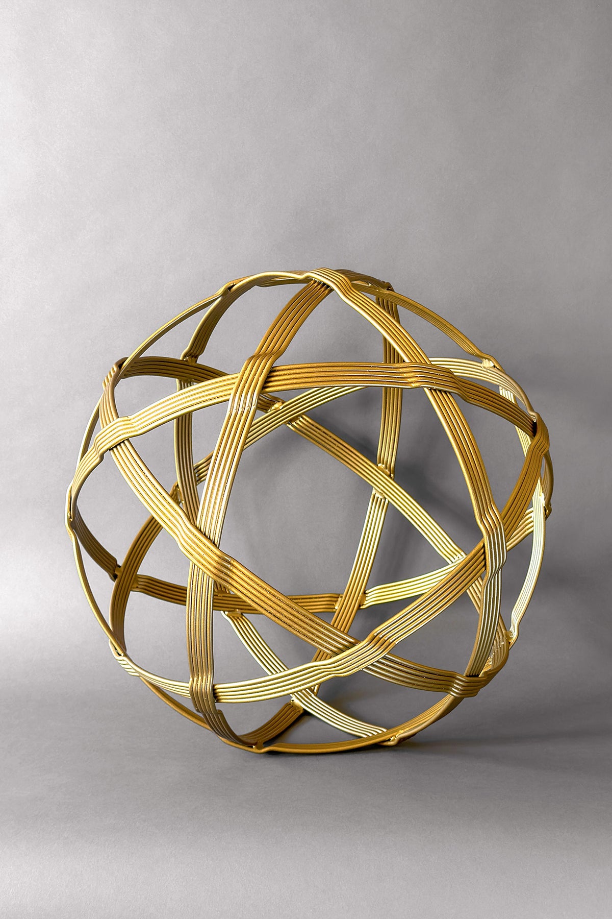 Gold Baby Chinlone Garden Orb, 19 inches, multi-strand steel bands woven into an open sphere