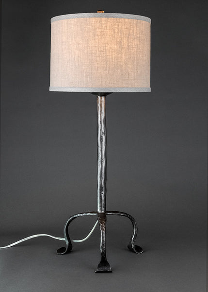 Simply Santa Fe forged iron lamp with a linen drum shade. 