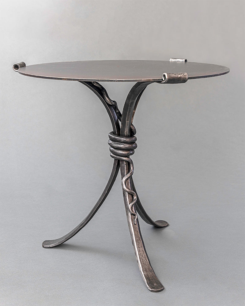 Wrought Iron Snake End Table with a rattlesnake design wrapped around the base of the table. Shown with a hand forged steel table top.