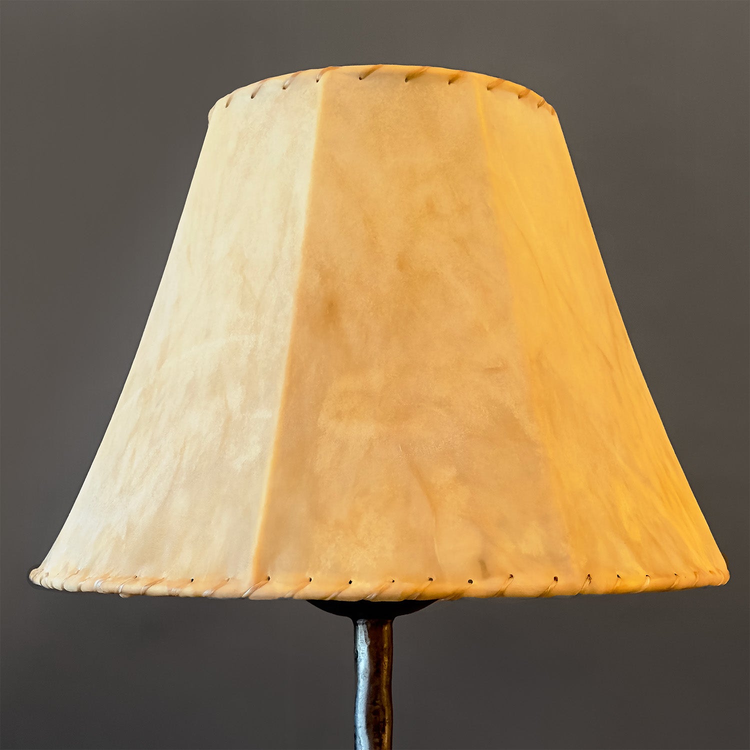 Raw sheepskin hide lamp shade. Showing the top of a wrought iron lamp