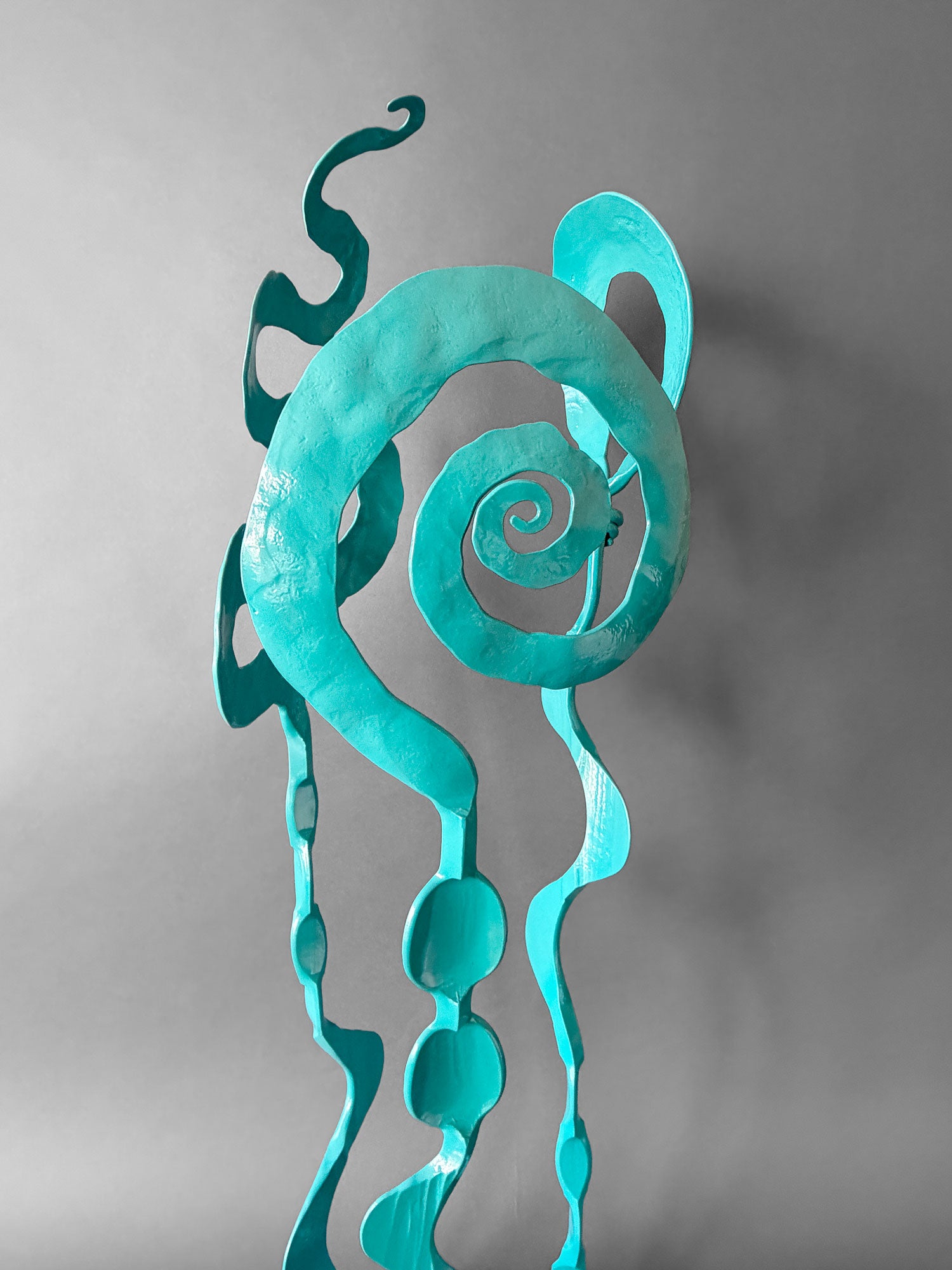 Hand forged turquoise sculpture detail showing the spiral bloom design.