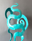 Close up of turquoise sculpture showing hand forged details.