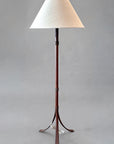 Rustic wrought iron floor lamp made from hand forged steel and paired with a woven linen shade.