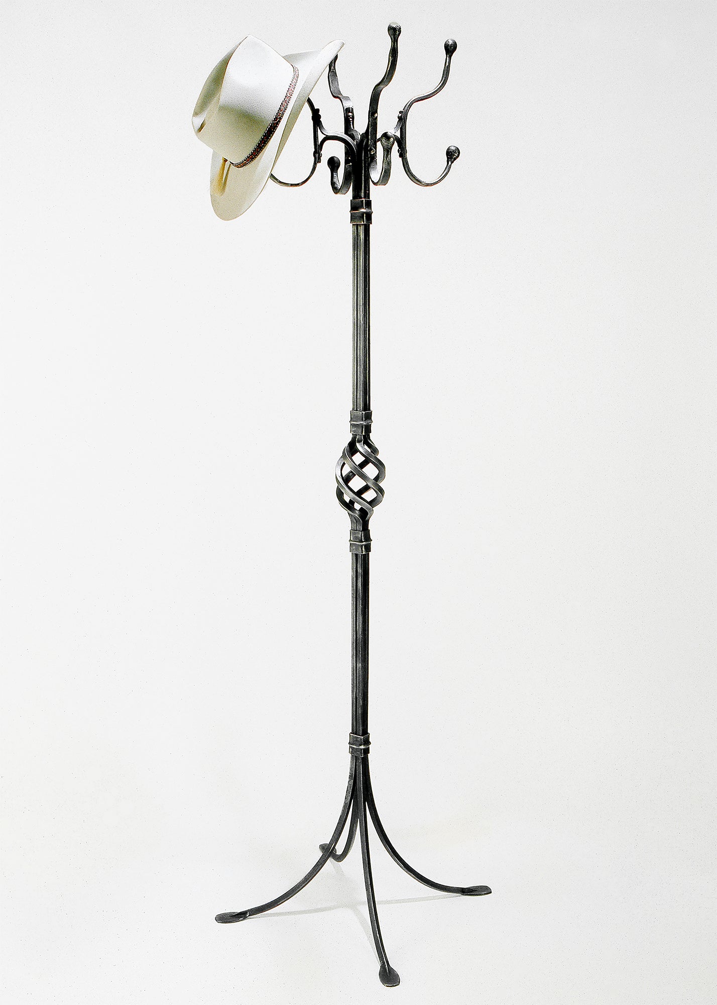 Hand forged wrought iron standing coat rack with multiple hooks. 