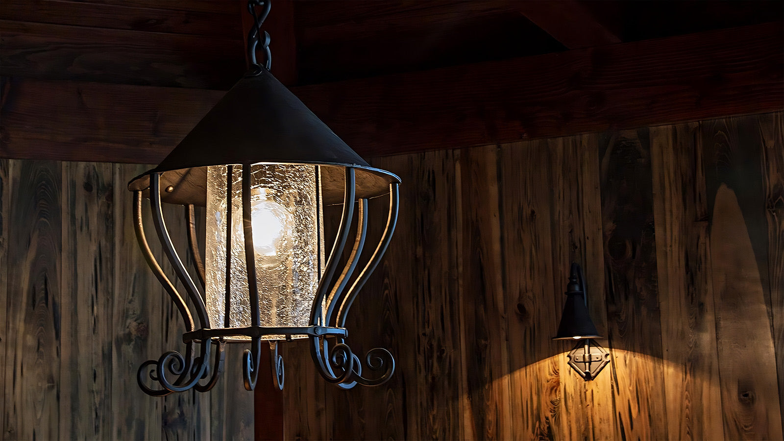 Handcrafted wrought iron light fixtures - featuring a hanging wrought iron lantern and a dropped entry sconce, artisan-made by New Mexico blacksmith Christopher Thomson, part of our iron lighting collection.