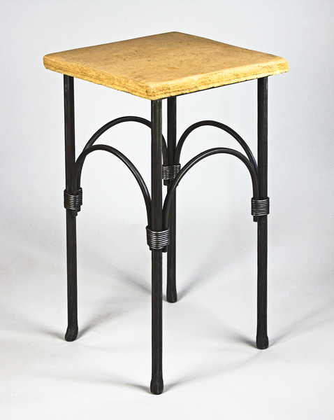 A forged steel pedestal table with a flagstone top.