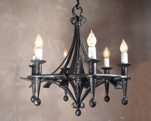 Hand forged Fleur Elegante Chandelier with six candle torch light bulbs.