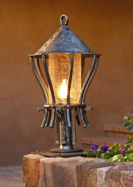 Hand forged outdoor Post Lantern installed along a walkway for pathway lighting. Made by blacksmith, Christopher Thomson in Santa Fe, New Mexico.