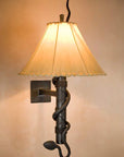 Wrought iron Stationary Snake Torch Wall Sconce with a hand forged rattlesnake wrapping around the torch stem and a rawhide sheepskin shade.