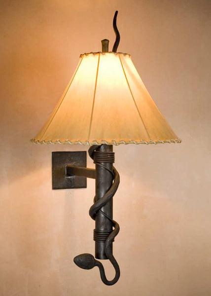 Wrought iron Stationary Snake Torch Wall Sconce with a hand forged rattlesnake wrapping around the torch stem and a rawhide sheepskin shade.