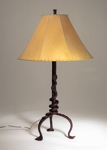 Western Rattlesnake wrought iron table lamp with a sheepskin shade.