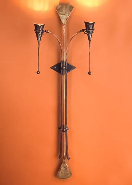 A 75" tall abstract, wrought iron "Torchiere Wall Sconce" with two calla lily lights on either side. 