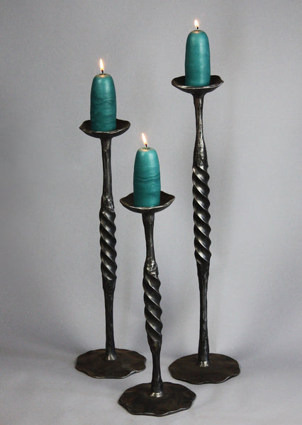 Three Spiral Wrought Iron Candlestick Holders made by blacksmith artist, Christopher Thomson - shown with large candles.
