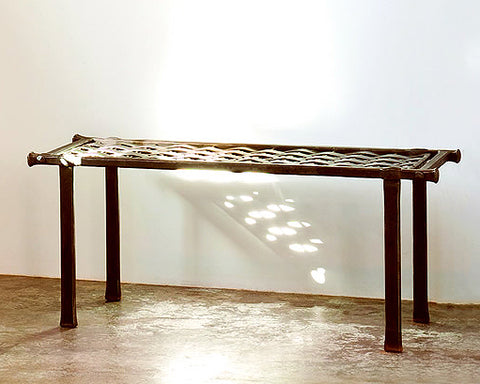 Woven Wrought Iron Bench made with long strands of woven forged steel.